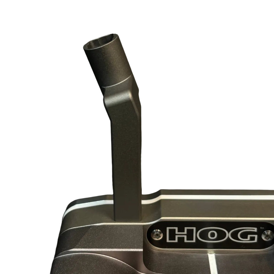 Close-up of a HOG golf putter head in a dark metallic gray finish, featuring a vertical neck and the HOG logo on the front, set against a dark textured background.